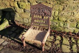 Asian folding chair with carved decorati