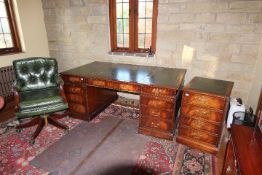 A large pedestal desk with inset leather