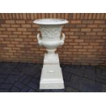 A white painted, cast iron garden urn of