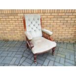 An upholstered mahogany library chair on