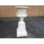 A white painted, cast iron garden urn of