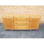 An Ercol Windsor sideboard with three ce