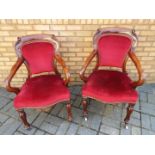 A pair of mahogany armchairs with red up