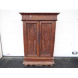 A twin door cupboard with carved decorat