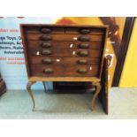 A raised chest or collectors cabinet hav