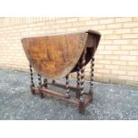 An oak, drop leaf, gate leg table on bar