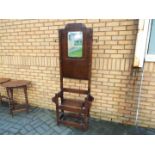 A hall stand with central mirror and box seat,