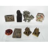Lot to include a white metal matchbox cover, black soapstone Buddhist lion on plinth,