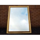 A large bevel edge wall mirror, approximately 105 cm x 135 cm.