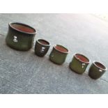 Five green glaze garden planters, largest approximately 27 cm (h).