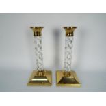 A pair of Waterford Crystal brass mounted candlesticks, approximately 27 cm (h).