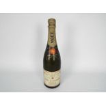 Moet & Chandon - A standard size bottle of 1973 Dry Imperial, no capacity or strength stated.