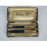 A Parker 51 fountain pen and pencil set with rolled gold caps,