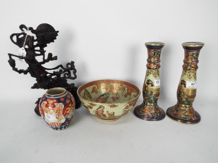 A Japanese bowl and pair of candlesticks,