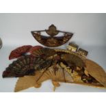A collection of hand fans, brass fan models, Asian hand puppet and other.