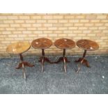 Four circular topped occasional or lamp tables on tripod supports, approximately 60 cm x 39 cm.