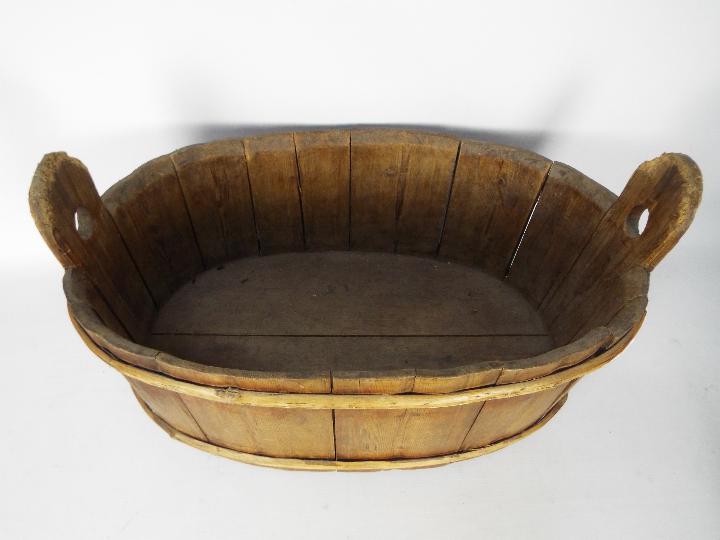 A vintage, oval wooden trough, approximately 33 cm x 60 cm x 37 cm. - Image 2 of 2