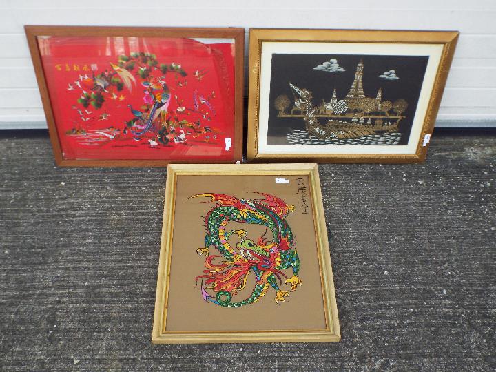 Three framed pieces of wall art to include embroidery of birds, picture of dragon and other,