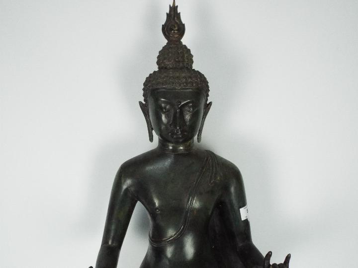 A large metal standing Buddha atop double lotus base, - Image 2 of 4