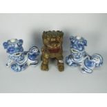 A blue and white Buddhist lion pair, approximately 25 cm (h) and one other.