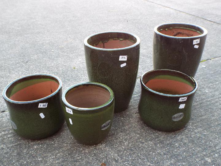 Five green glaze garden planters, largest approximately 35 cm (h).