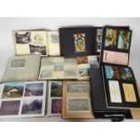 A quantity of albums containing photographs, postcards, tour brochures,