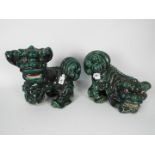 A pair of green glaze Buddhist lions, largest approximately 25 cm (h).