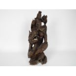 A wooden carving depicting Guanyin riding on a Qilin,