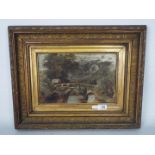 A framed oil on canvas depicting a landscape scene of a bridge across a stream, signed lower left,