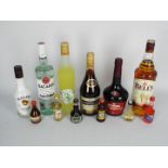A mixed lot of drink to include a 1 litre bottle of Bells, 700 ml bottle of Bacardi,