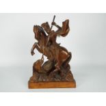 A wooden carving depicting St George and the dragon,