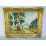 A large framed oil on board landscape scene depicting a path through trees with a mountainous