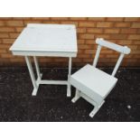 A white painted traditional school desk and chair,