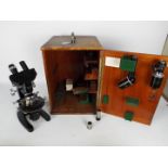 A Cooke, Troughton & Simms binocular microscope, contained in wooden case with accessories.