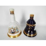 Two 70cl Bells commemorative whisky decanters with contents.