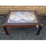 A coffee table with map image to the top and brass mounts, approximately 36 cm x 76 cm x 59 cm.