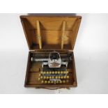 A Blick Aluminium Featherweight typewriter contained in wooden carry case.