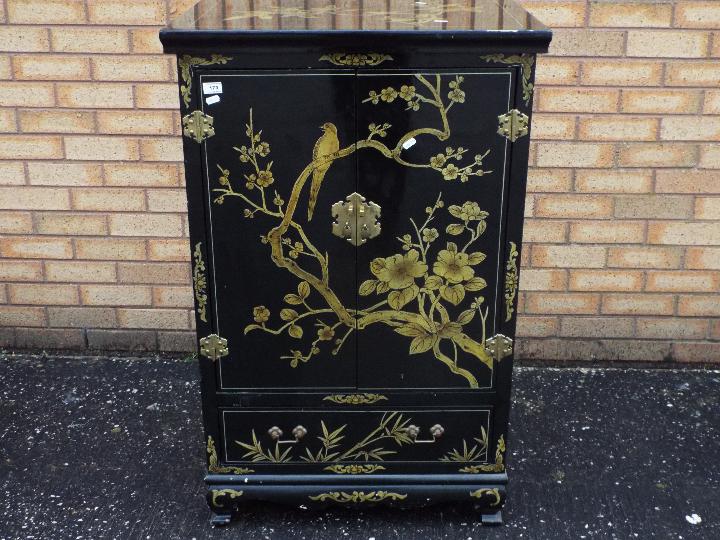 An Oriental twin door, brass mounted, ca