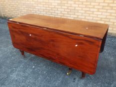 A mahogany drop leaf table with turned s