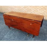 A mahogany drop leaf table with turned s