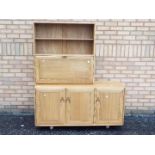 An Ercol sideboard with upper shelving s