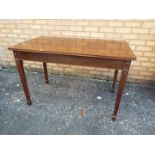 A mahogany table with carved detailing a