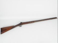 A single barrel percussion 12 gauge shotgun, 79 cm barrel with ramrod and working action,
