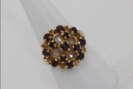 A lady's 9 carat gold dress ring, stamped 375 set with thirteen garnets, approx 4.