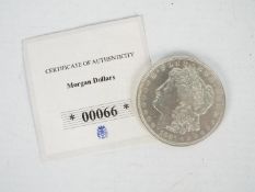 A 1921 silver Morgan Dollar, with certificate of authenticity.