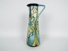 Moorcroft - A Moorcroft Pottery jug of slender form decorated in the Calla Lily pattern,