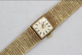 Omega - a lady's Omega wristwatch with 9 carat gold case and 9 carat gold textured bracelet with