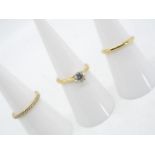 A Diamond Three Ring Set, comprising a central 18 carat gold solitaire set with a 75 point diamond,