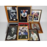 A collection of framed images of footballers and boxers, predominantly signed,