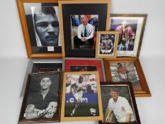 A collection of framed images of footballers and boxers, predominantly signed,